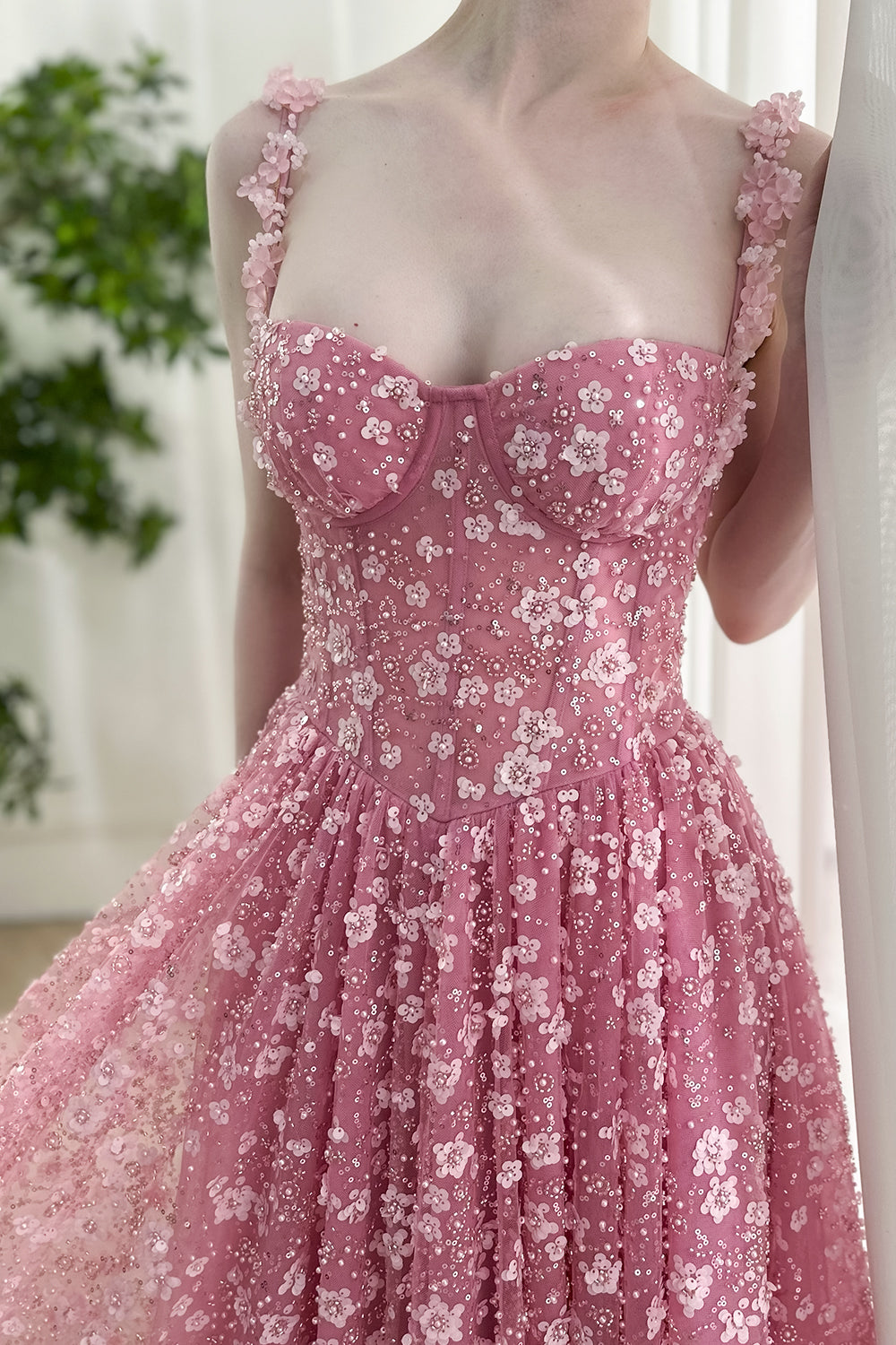 Feminine dusty rose gown with 3D appliqué straps, corset style bodice, shimmering sequin embellishments, suitable for luxury occasions