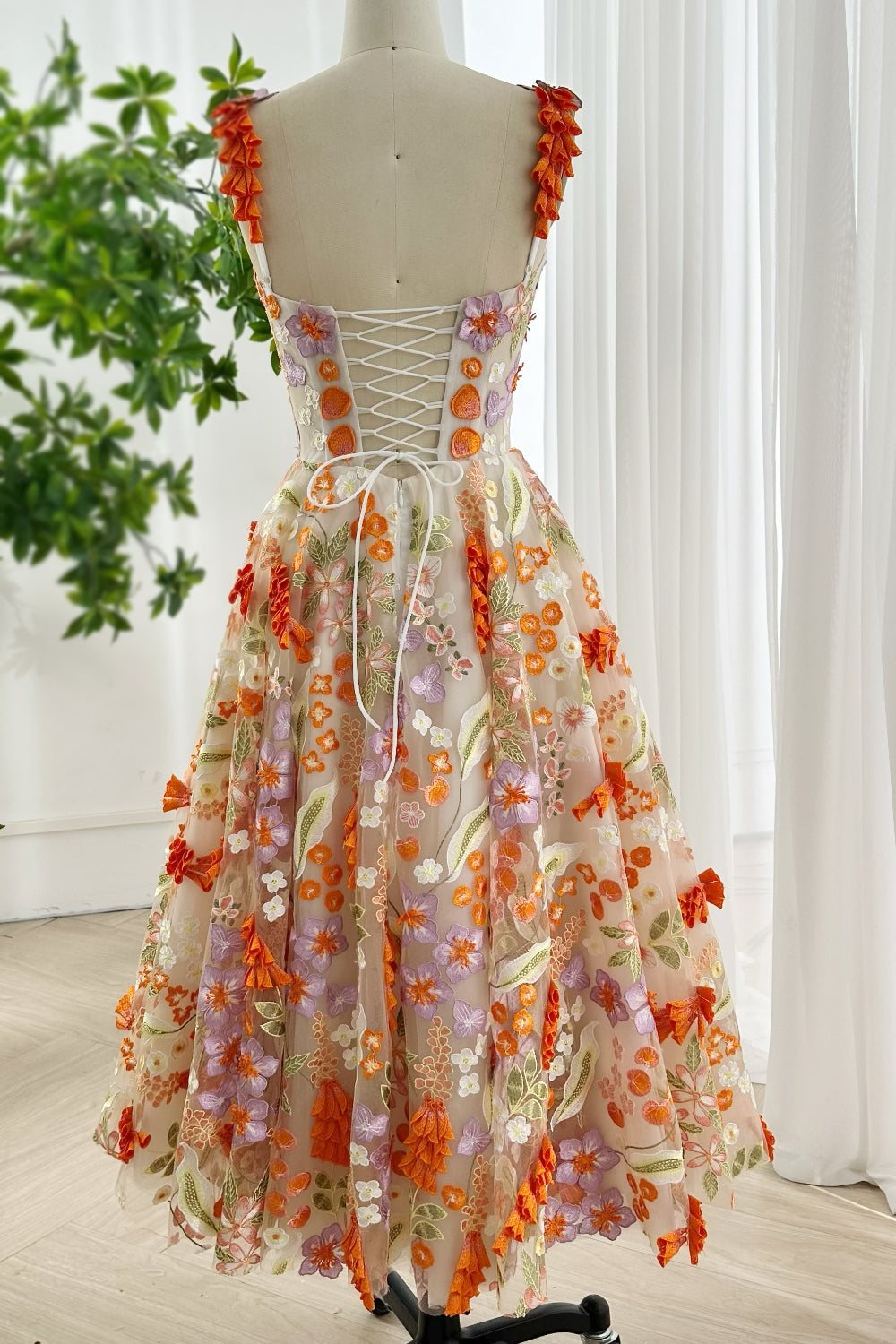 Rear full length shot embroidered floral dress with corset back design and 3D appliqué details for romantic events