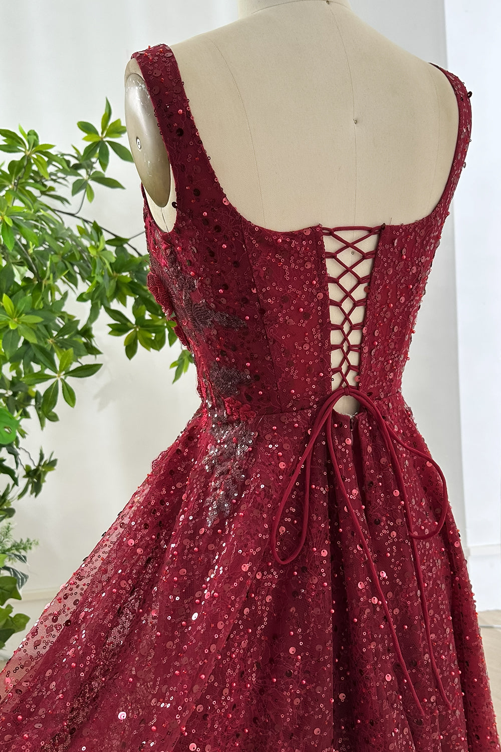 Corset channels grommets macro, textured sequins, floral motifs, satin cord, midriff emphasis, artisan workmanship, photogenic boutique setting composition