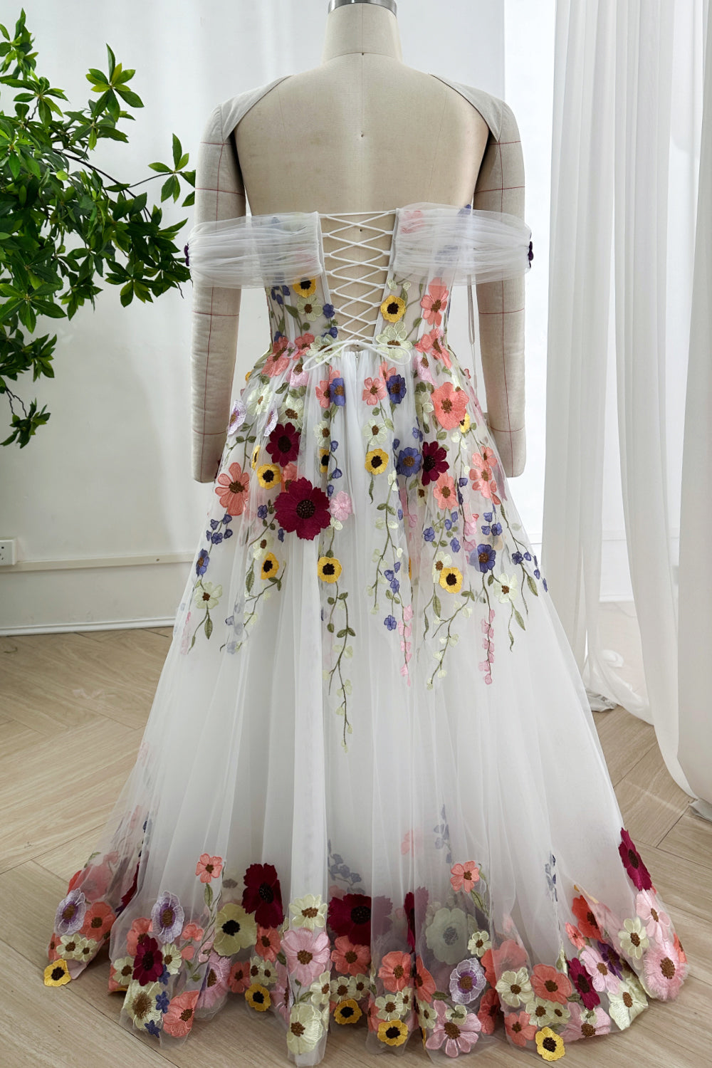 Floorlength tulleskirt finished colorful hem presenting artistic botanical motif suitable celebratory occasion
