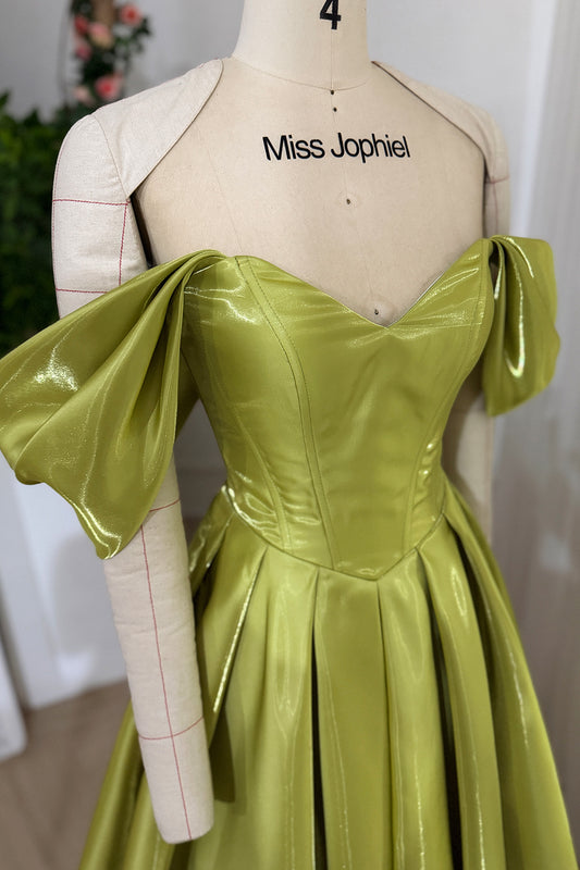 Lime shimmer dress closeup showing sculpted neckline paneled torso folded arm accents shiny textured surface