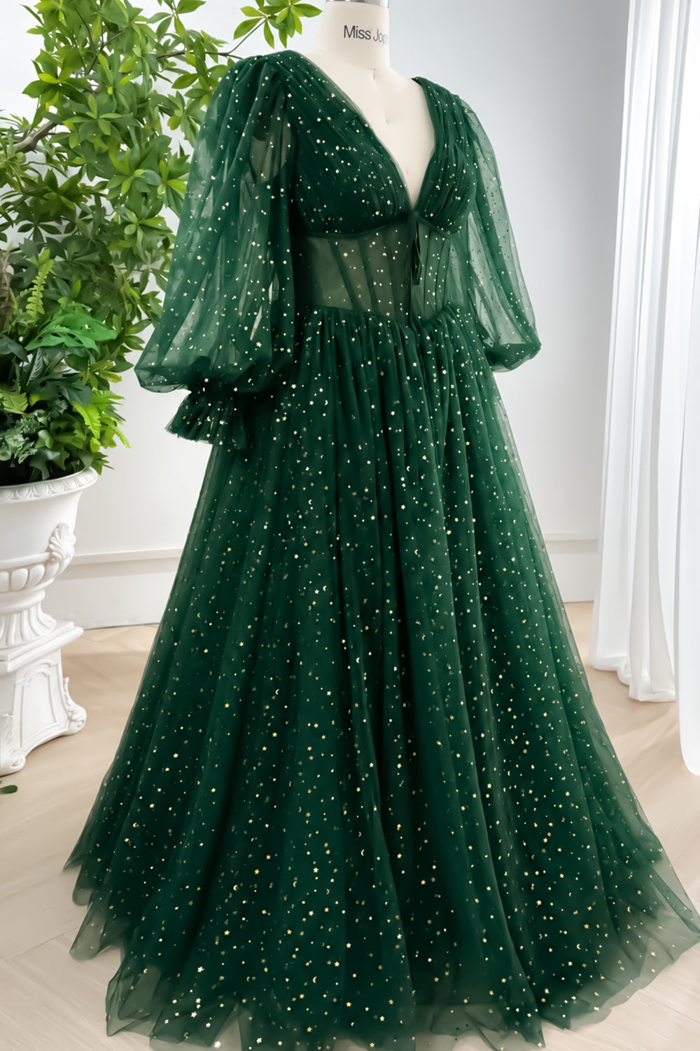 Robe de soirée bleu marine corsetée, décolleté en V, manches longues bouffantes et tulle étoilé