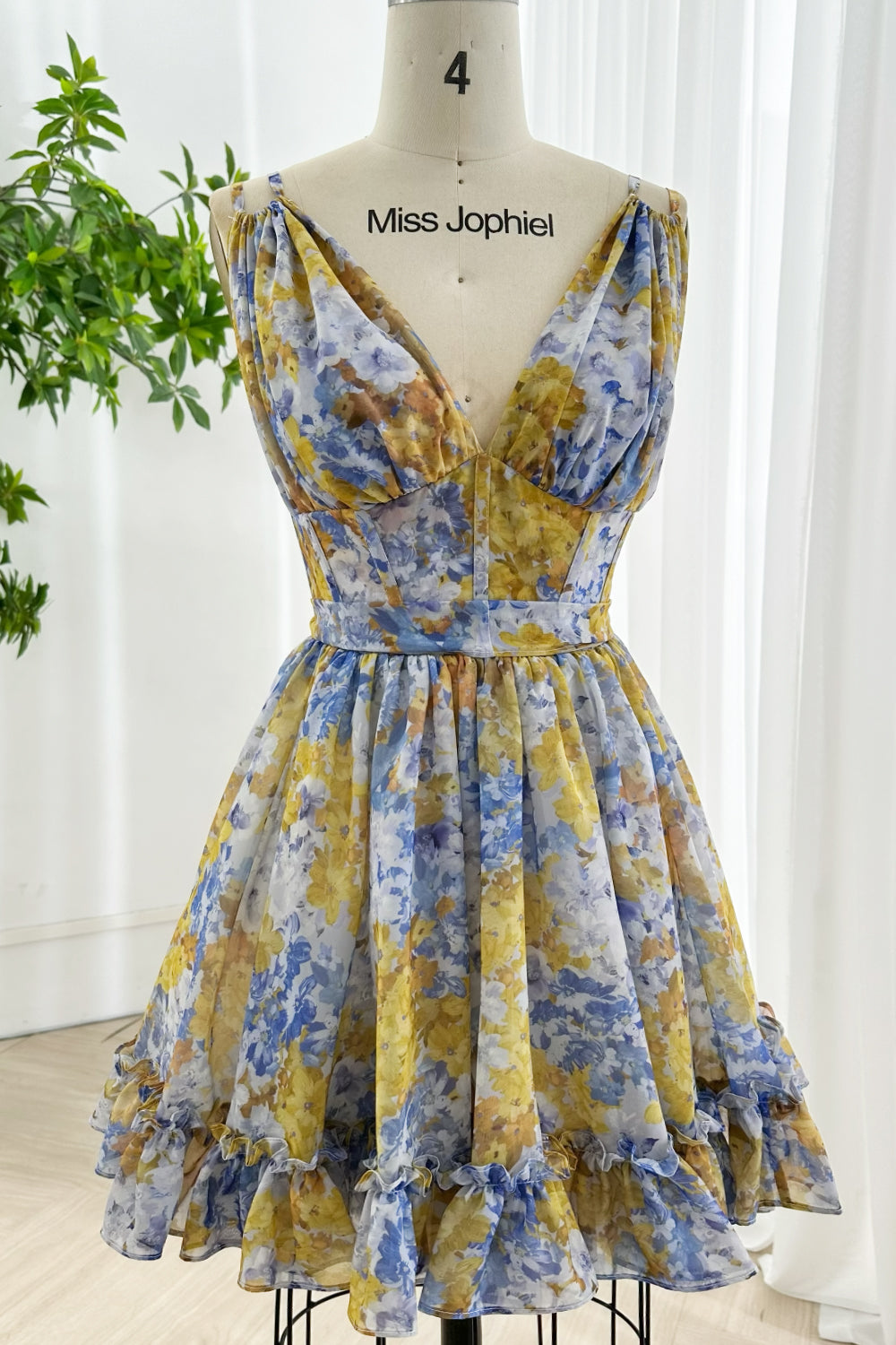 Romantic sleeveless floral mini dress featuring A-line silhouette, ruffle hem, and feminine design for weddings parties holidays