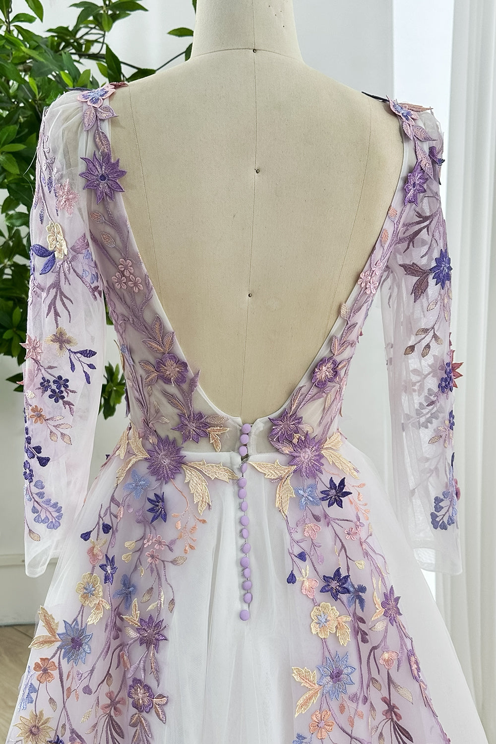 Luxury lavender gown deep V back floral applique accents button closure long sleeves flowing tulle skirt designed sophisticated weddings