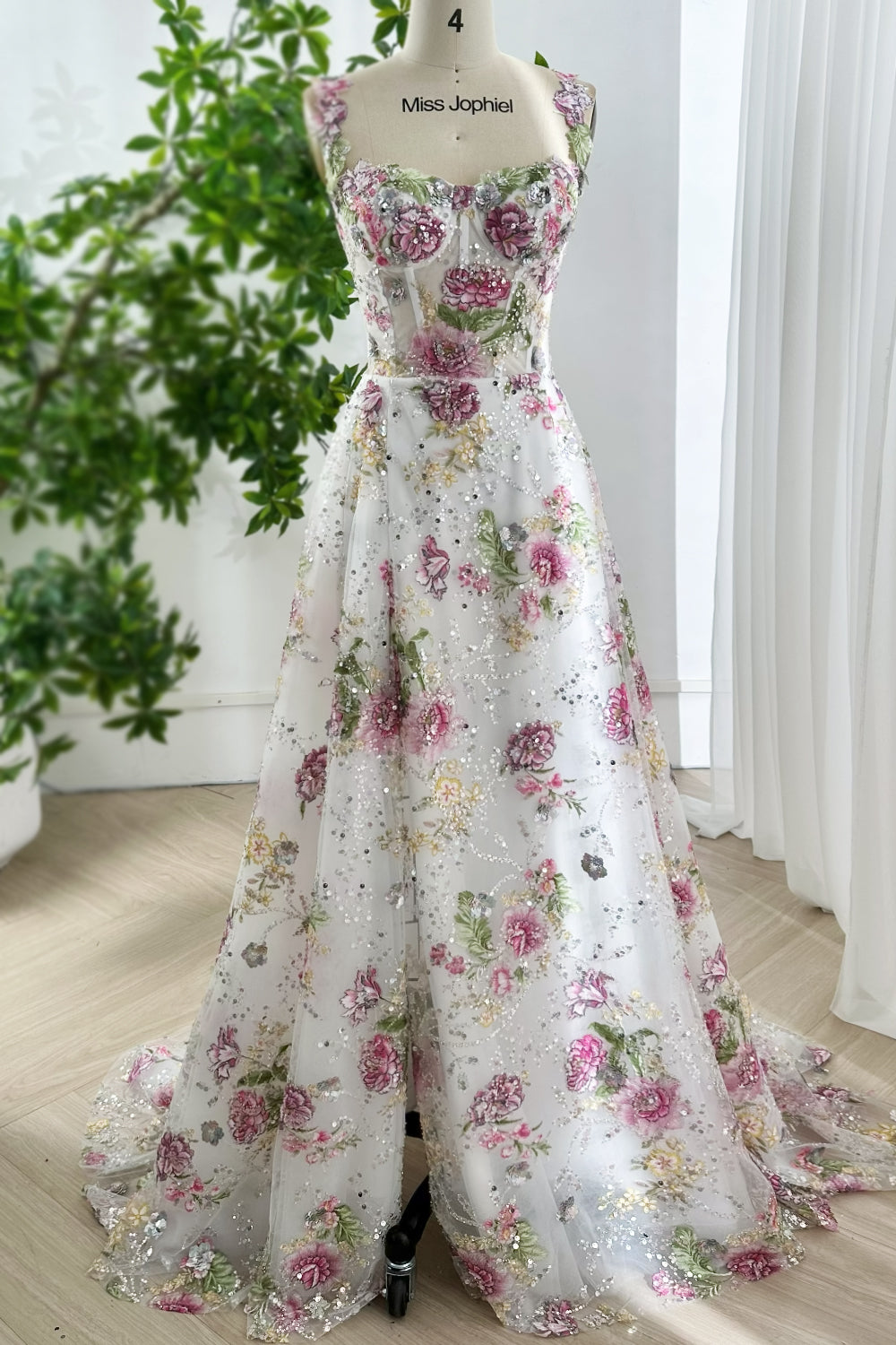Elegant garden style ivory ball gown featuring shimmering sequin accents, full length floral skirt, structured embroidered bodice, graceful design