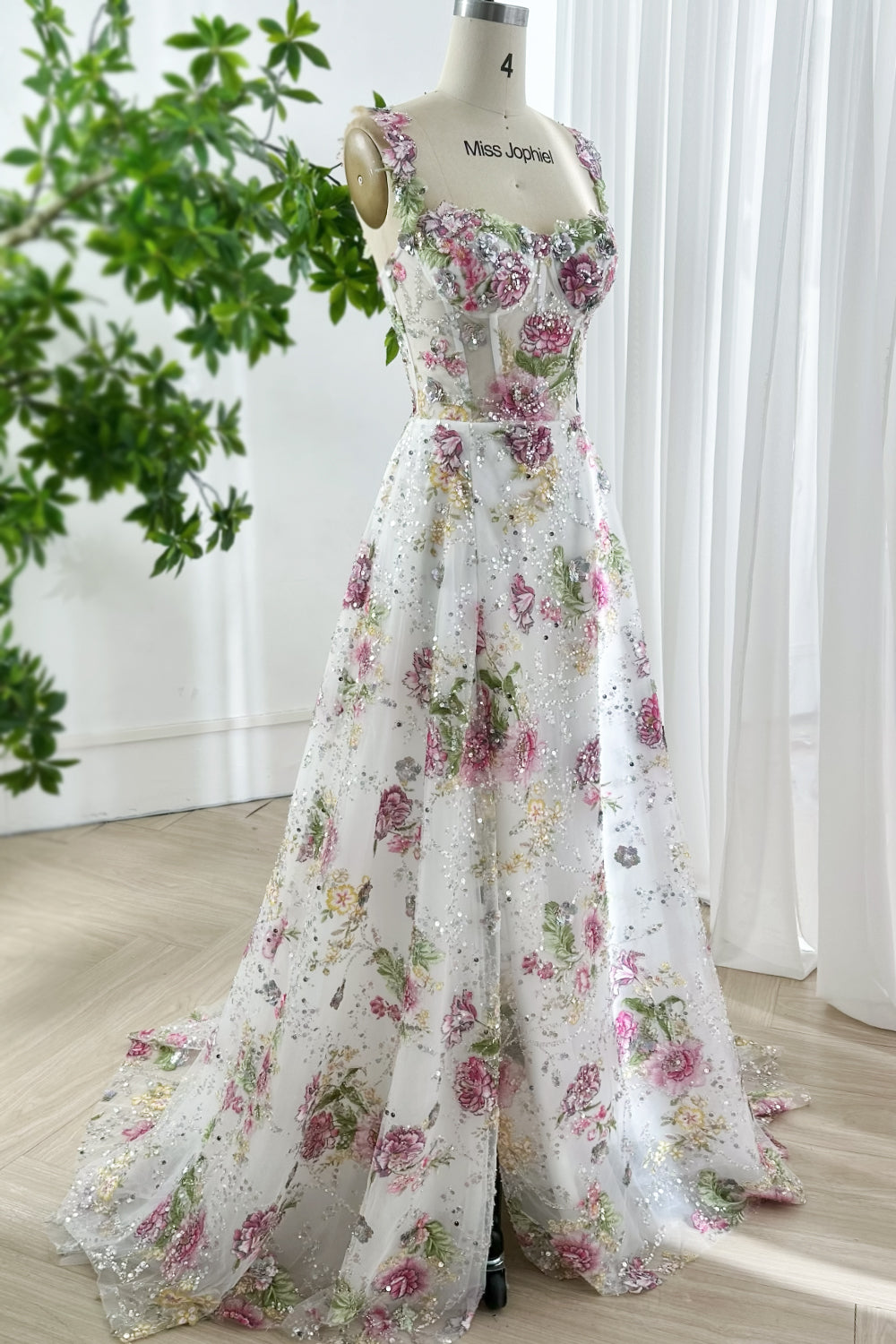 Elegant pink blossom embroidered dress with flowing skirt, sheer floral overlay, sleeveless straps, sparkling sequins, styled for sophisticated events