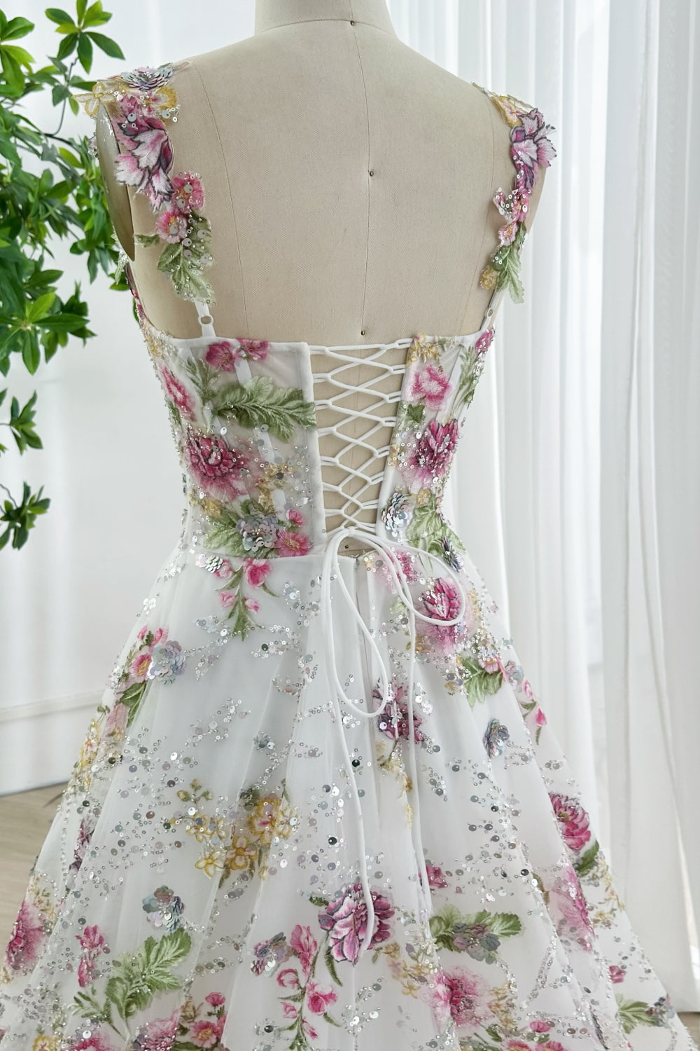 Charming corset back gown featuring multicolor floral embroidery, fitted bodice, romantic wide straps, intricate sequins, designed for glamorous evenings