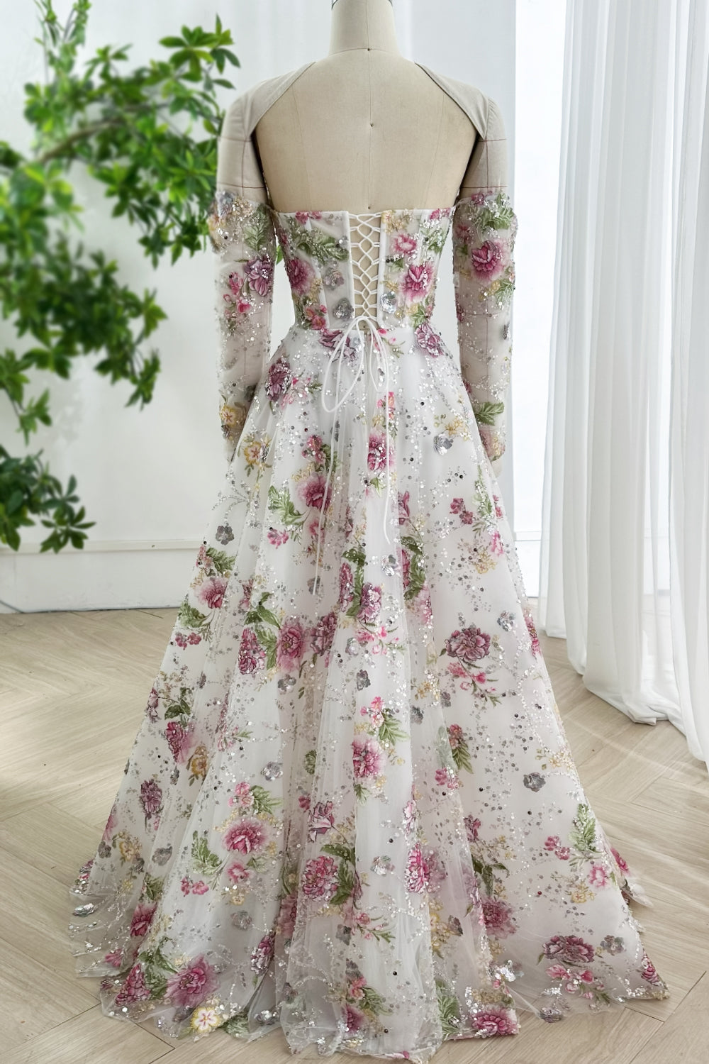 Backview laceup closure grommet lacing romantic train hem blooms scattered organza lining ethereal motion graceful perspectiv