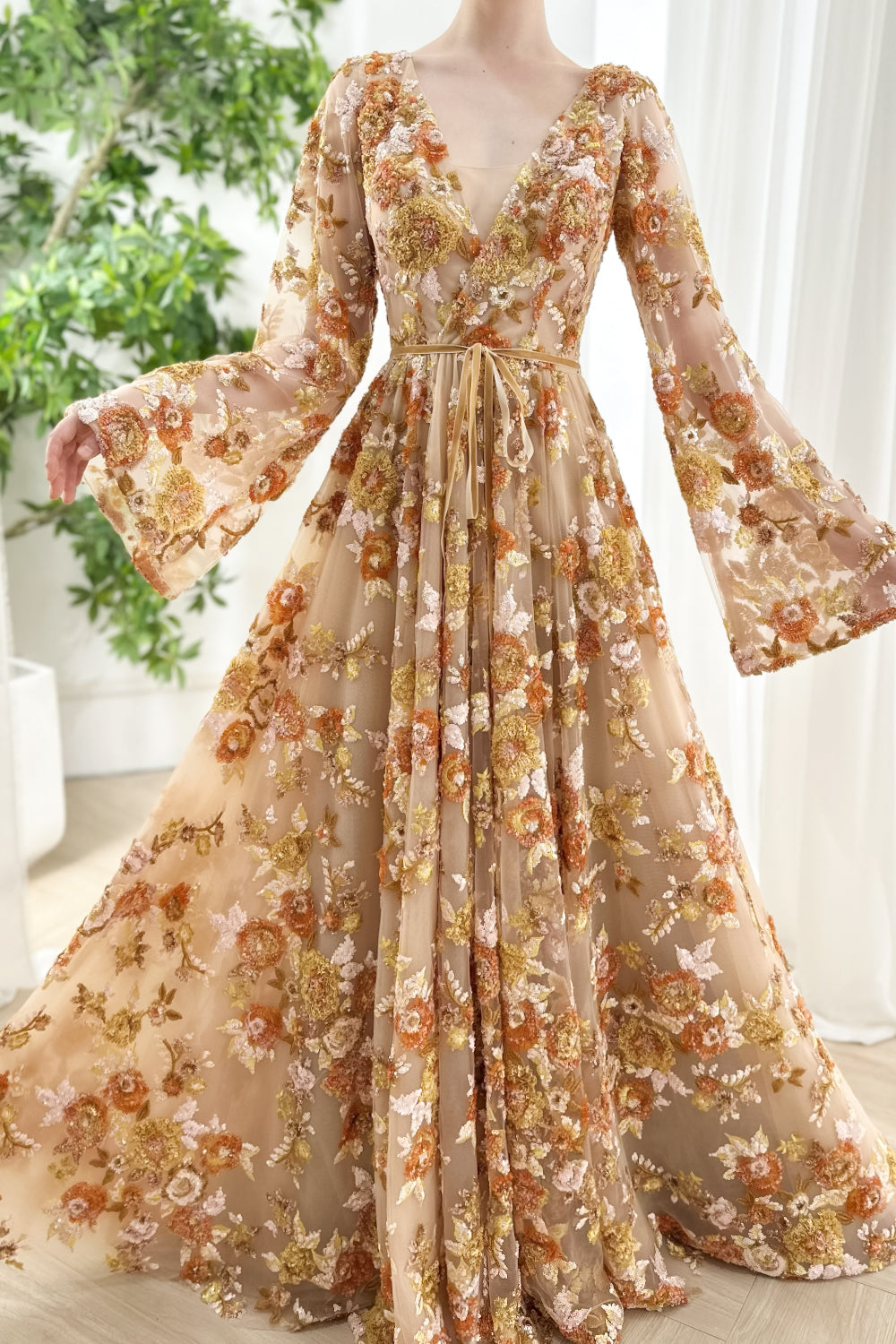 Flowing-nude overlay floralized-embroidery V-shaped-front empire-seam flared-cuffs swirling-skirt fitted-midriff