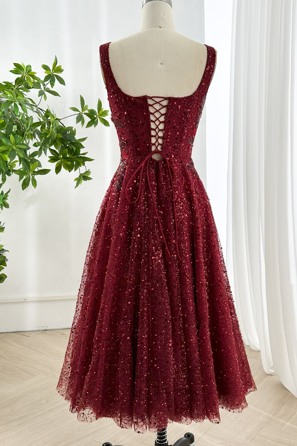 Rear lacing corsetry, ribbon tie, scoop back, structured panels, supportive fit, festive soirées readiness, midi hem, studio drape curtain backdrop