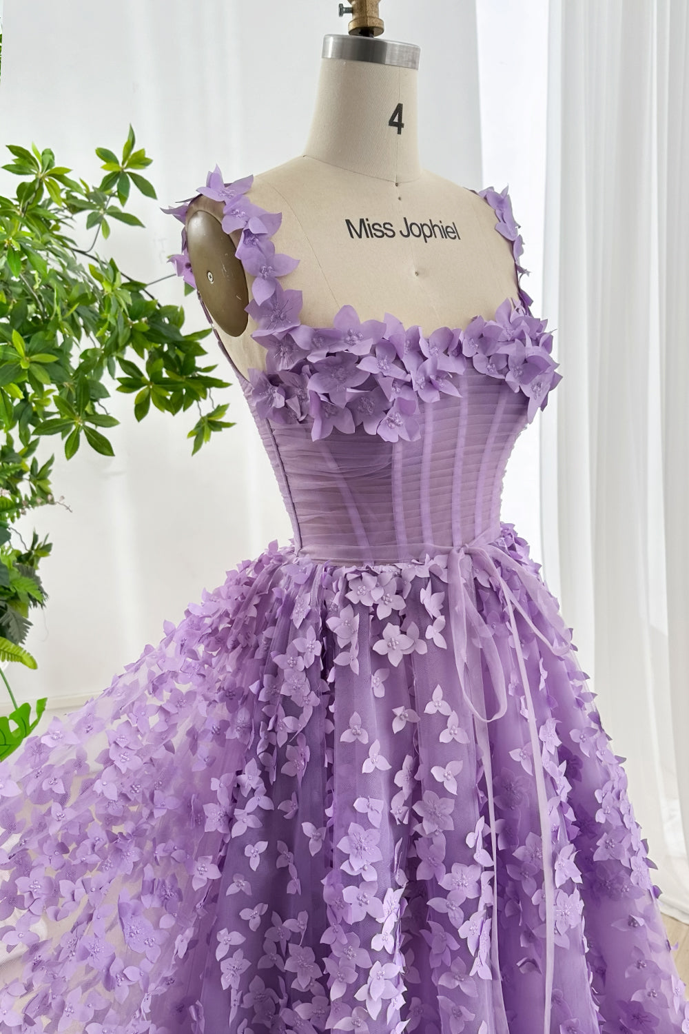 Closeup of lavender dress corset bodice with 3D flower detailing highlighting craftsmanship texture and couture quality design