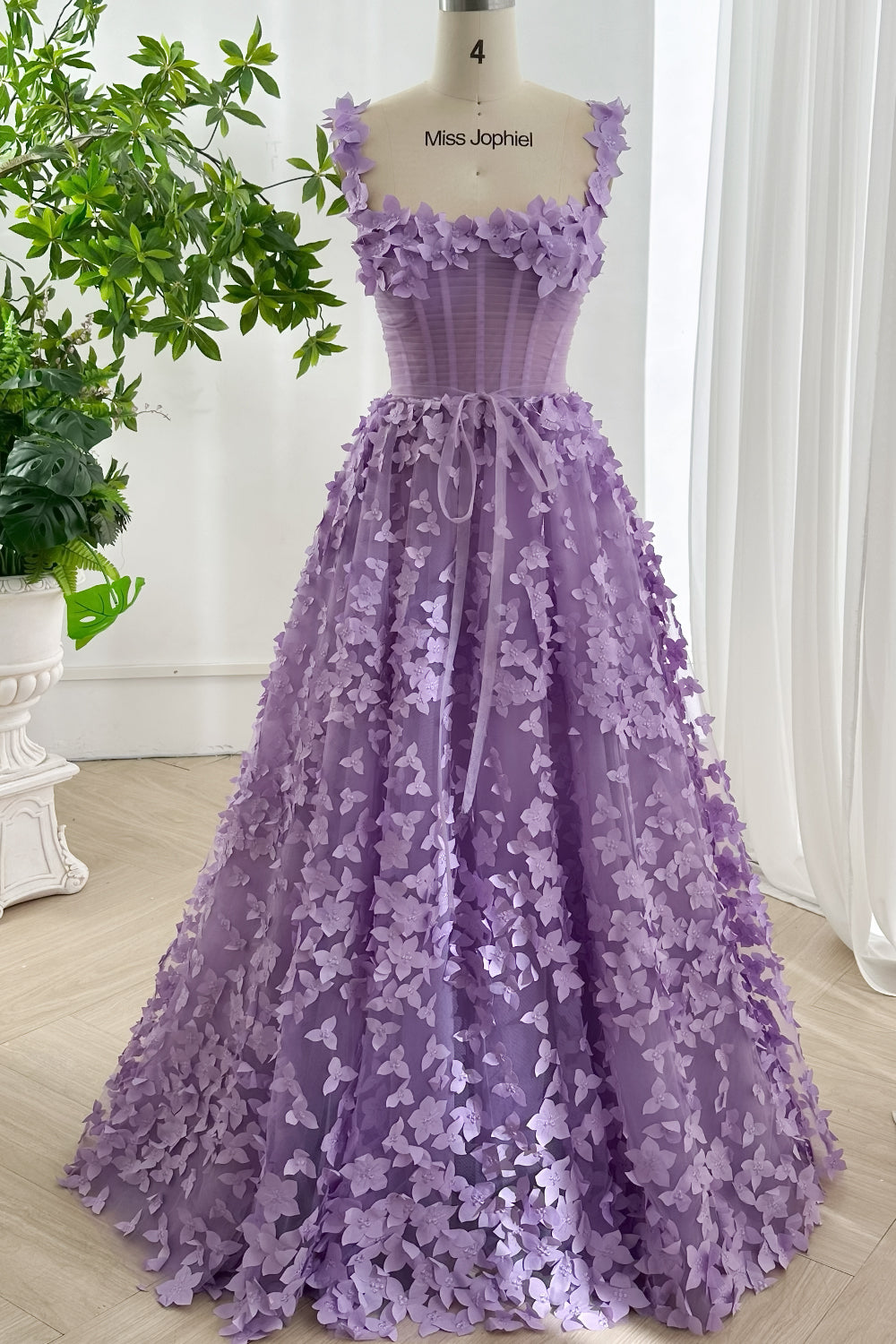 Front view of lavender romantic tulle dress featuring corset bodice flower straps and softly flared A-line silhouette detail