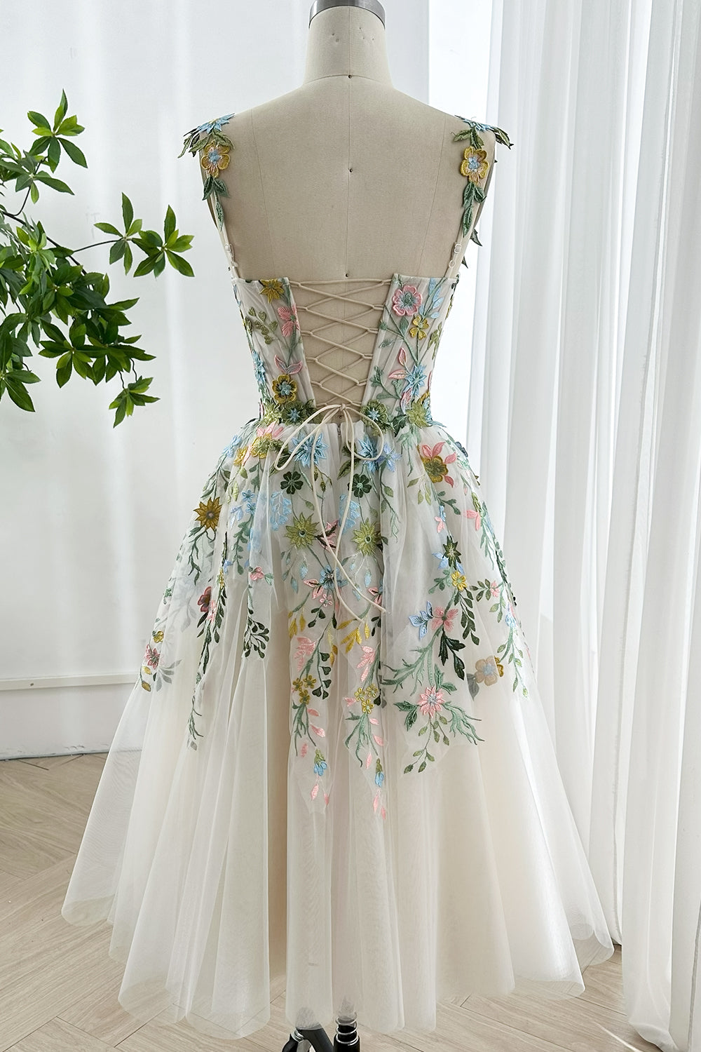 Ivory botanical floral embroidered tulle dress showing back lace up closure vibrant flower embroidery fine artisan detailing