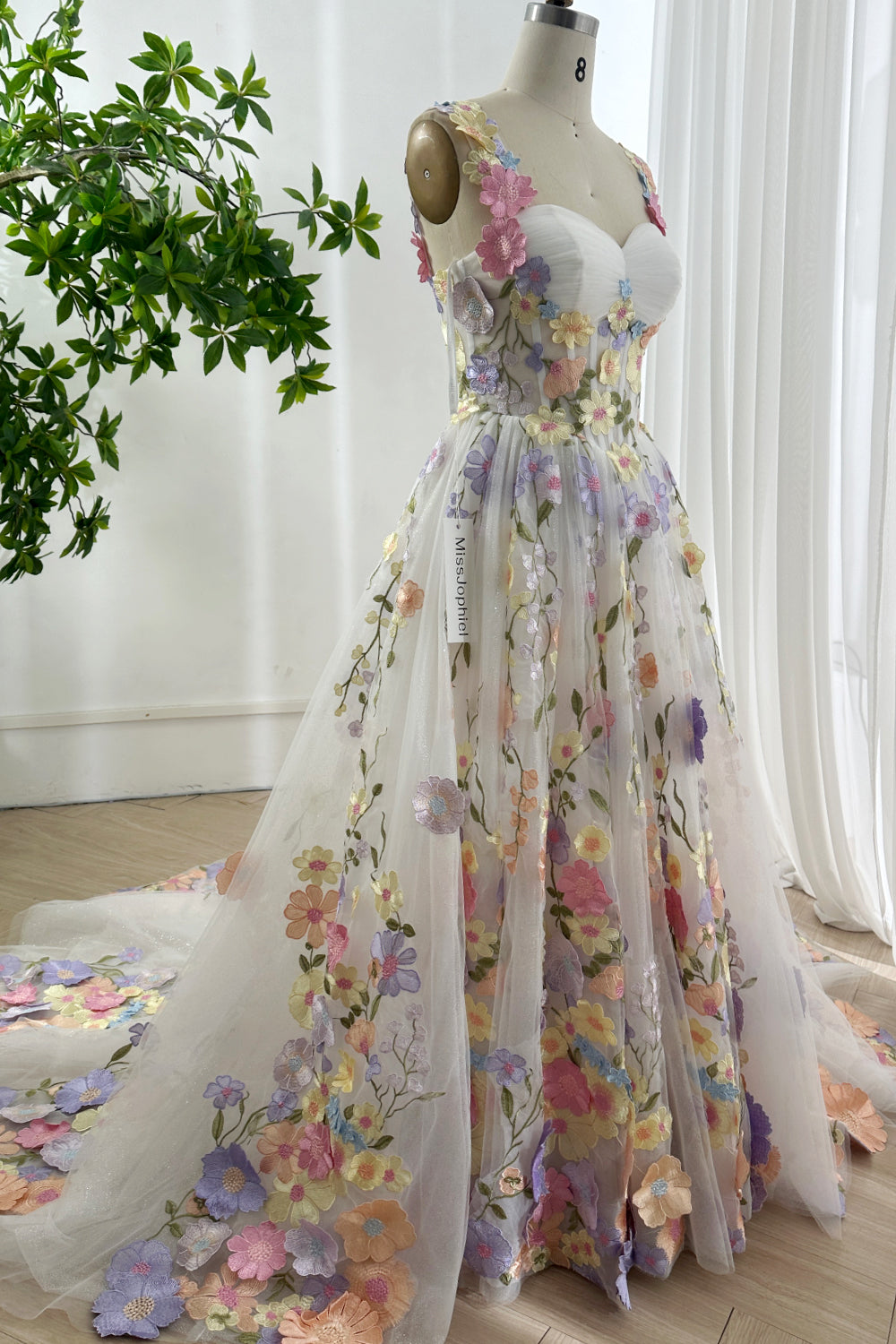 Side view of multicolor glitter tulle floral gown with lace-up back and soft A-line silhouette perfect for garden prom events