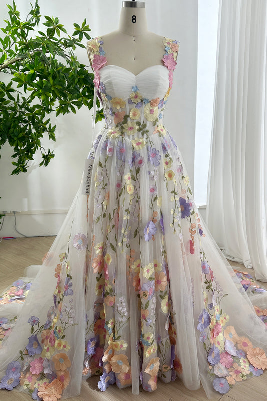 Front view of glitter floral embroidered pastel tulle gown with sweetheart neckline and sparkling train designed for elegant weddings
