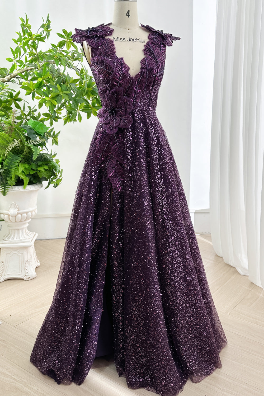 Elegant amethyst sequin gown with 3D floral embellishment cascading from shoulders to waist creating sophisticated evening style