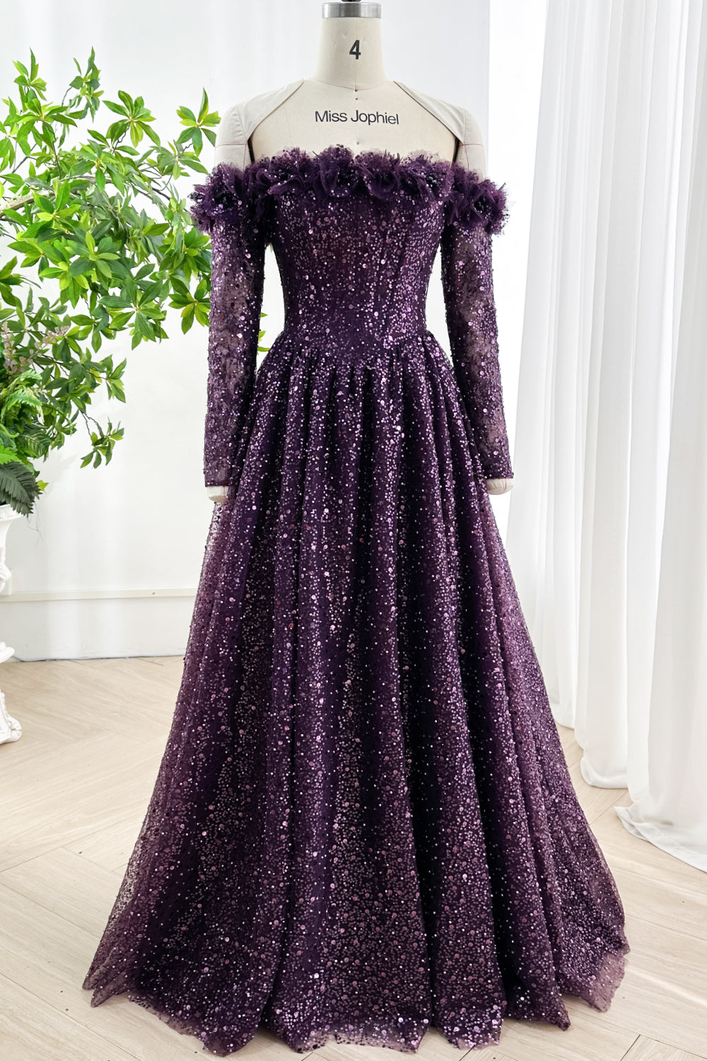 Front view of purple sequin evening dress with off-shoulder neckline and long sleeves designed for gala and prom events