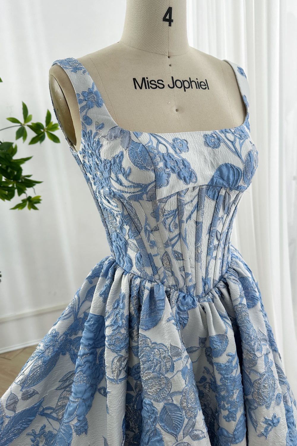 Square neckline bodice with visible boning structure in silver metallic brocade.