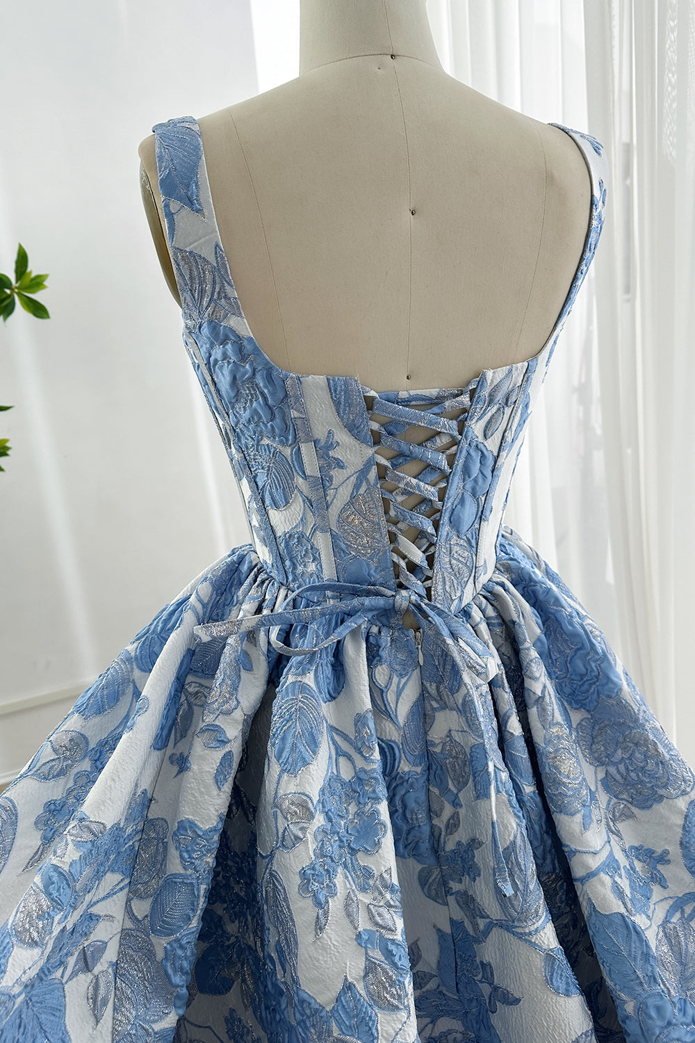 Back close-up featuring ribbon lacing on a periwinkle floral jacquard corset.