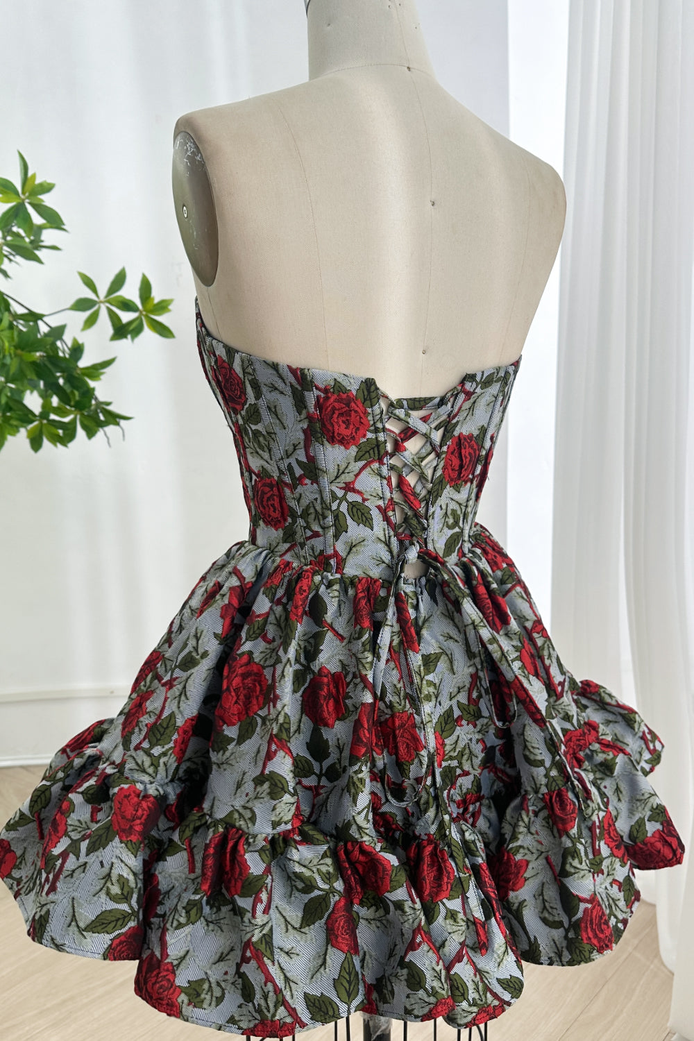 Laceup back floral aline celebration gown revealing adjustable crisscross closure voluminous skirt graceful rear perspective