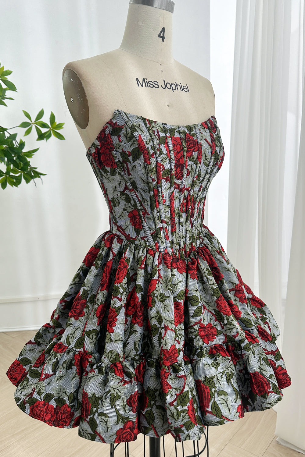 Vintage inspired ruffled cocktail dress silhouette displaying contoured torso playful flare boutique interior atmosphere