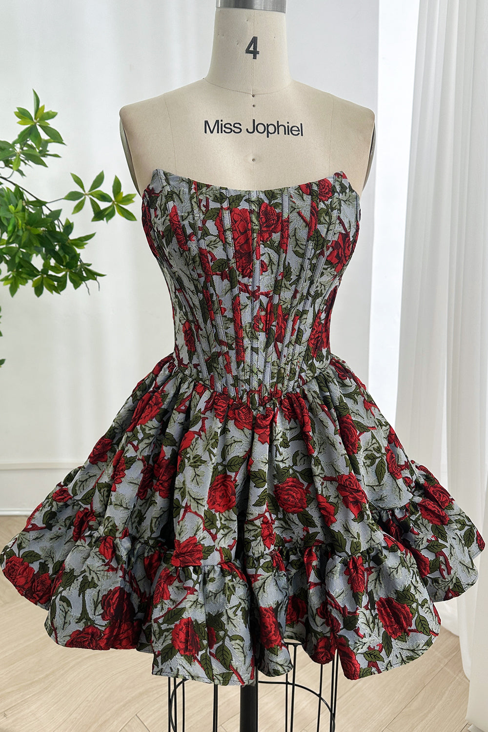 Strapless corset mini floral jacquard partywear showcasing sculpted boning bodice tiered ruffles mannequin studio setting