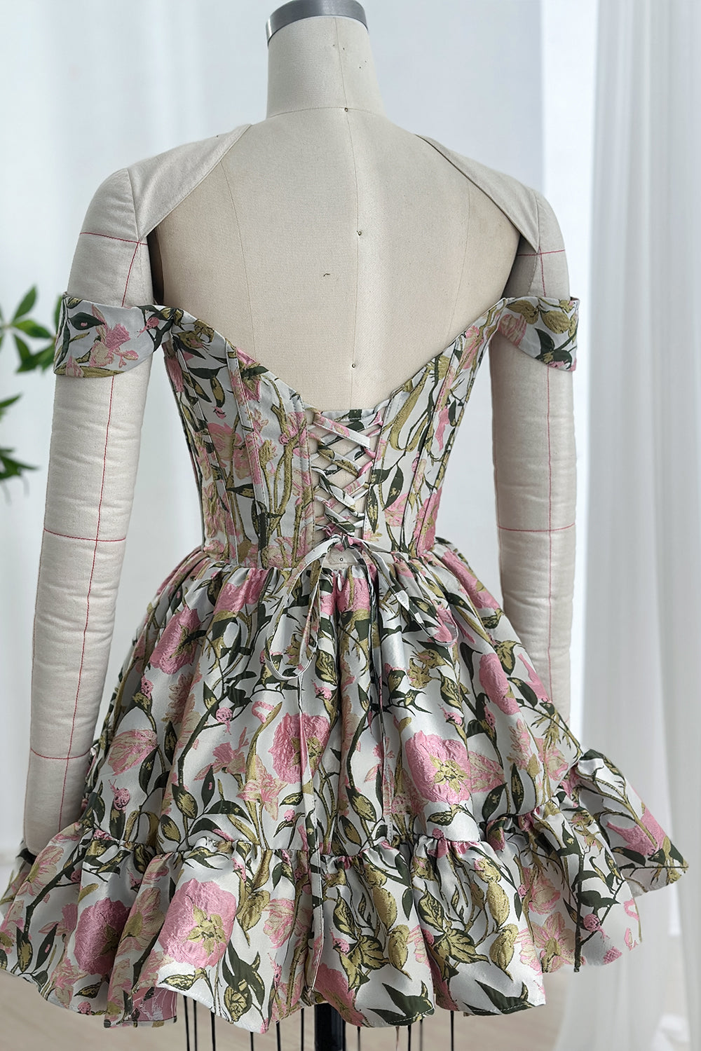 Rear perspective crisscross lacing adjustable closure contoured back panel blooming pattern flared tier whimsical elegance atelier showcase