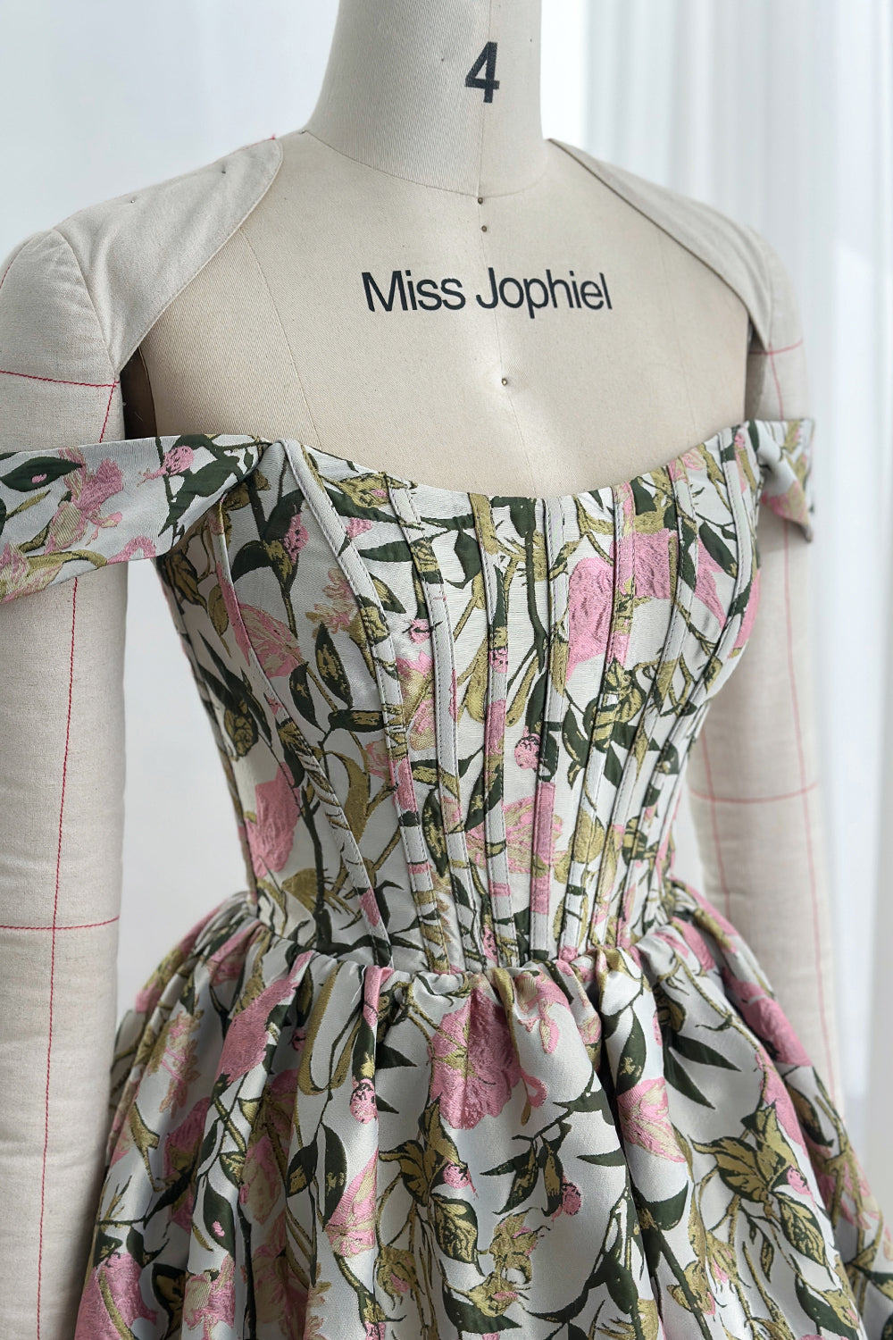 Closeup portrait detail structured boned torso refined tailoring textured weave petal motifs sophisticated celebration garment photography