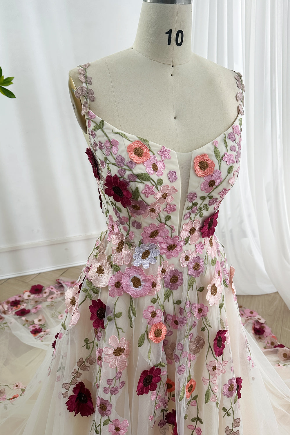 Structured illusion bodice adorned vivid embroidery highlighting feminine waistline beneath translucent overlay artistry