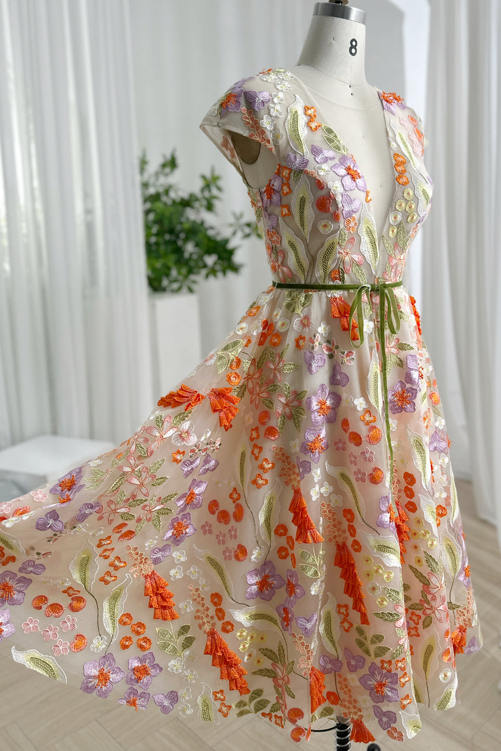 Flowing garden flower midi silhouette swirling softly displaying airy mesh overlay colorful petals elegant motion graceful daytime celebration