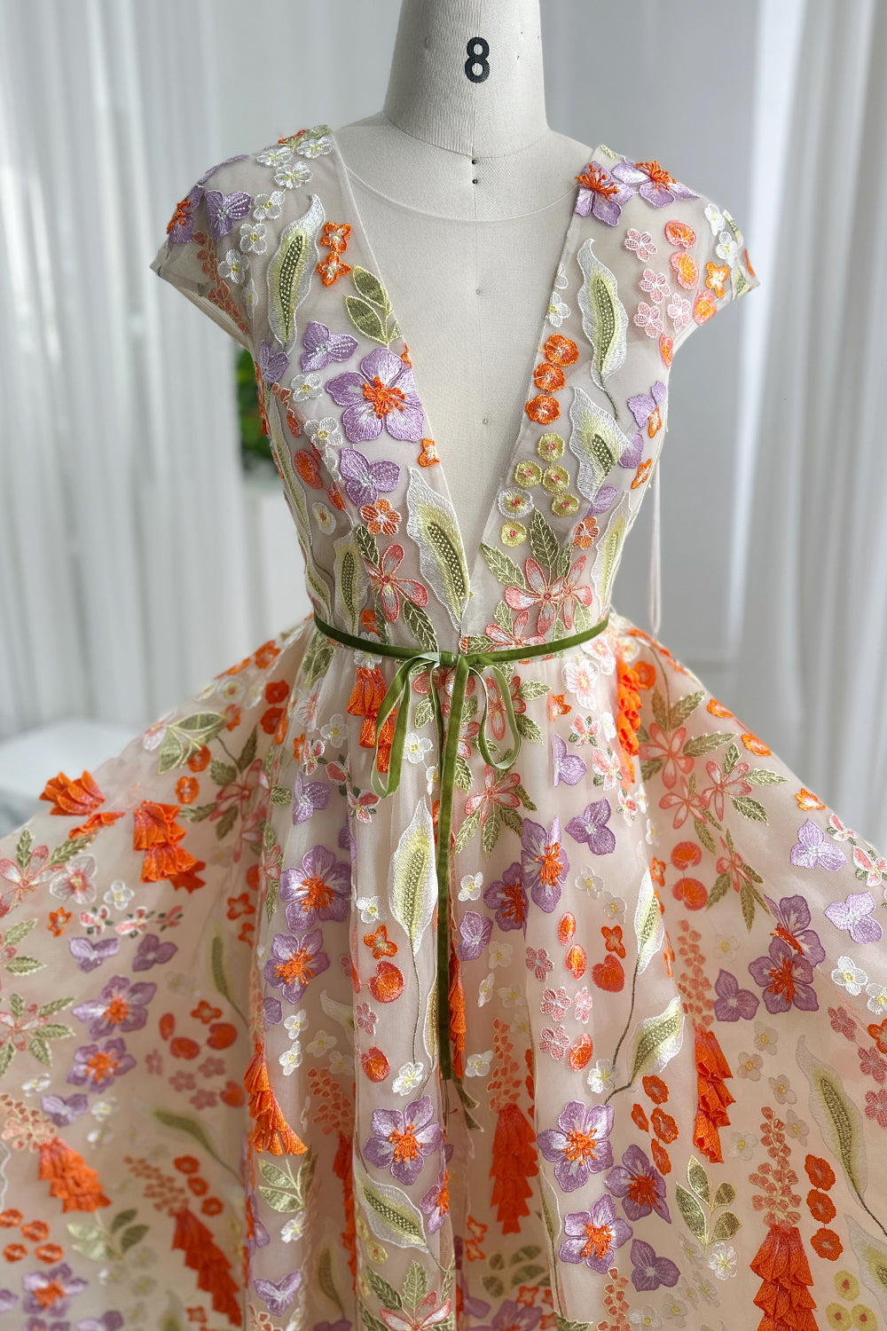 Romantic spring botany lace illusion bodice showcasing lavender orange blossoms refined tailoring artistic embroidery airy lightweight structure