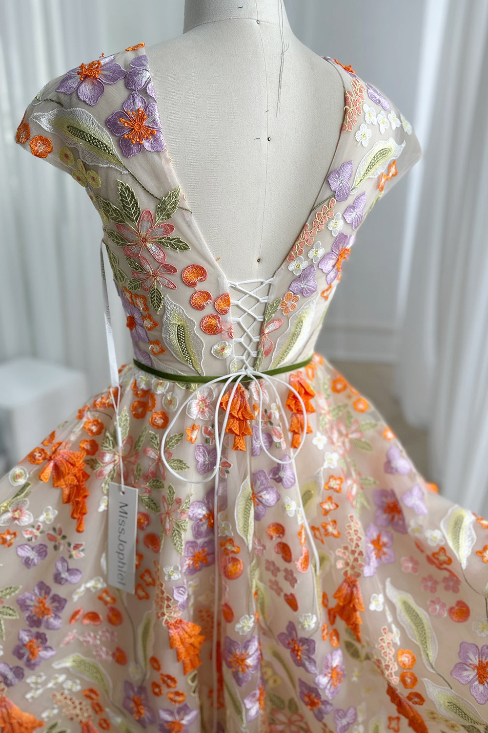 Corsetback botanical embroidered tulle midi design revealing intricate stitching adjustable lacing delicate transparency charming handcrafted aesthetic