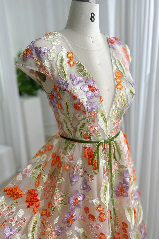 Delicate botanical embroidered Vneck tulle bodice featuring cap sleeves pastel blossoms artistic couture craftsmanship feminine silhouette