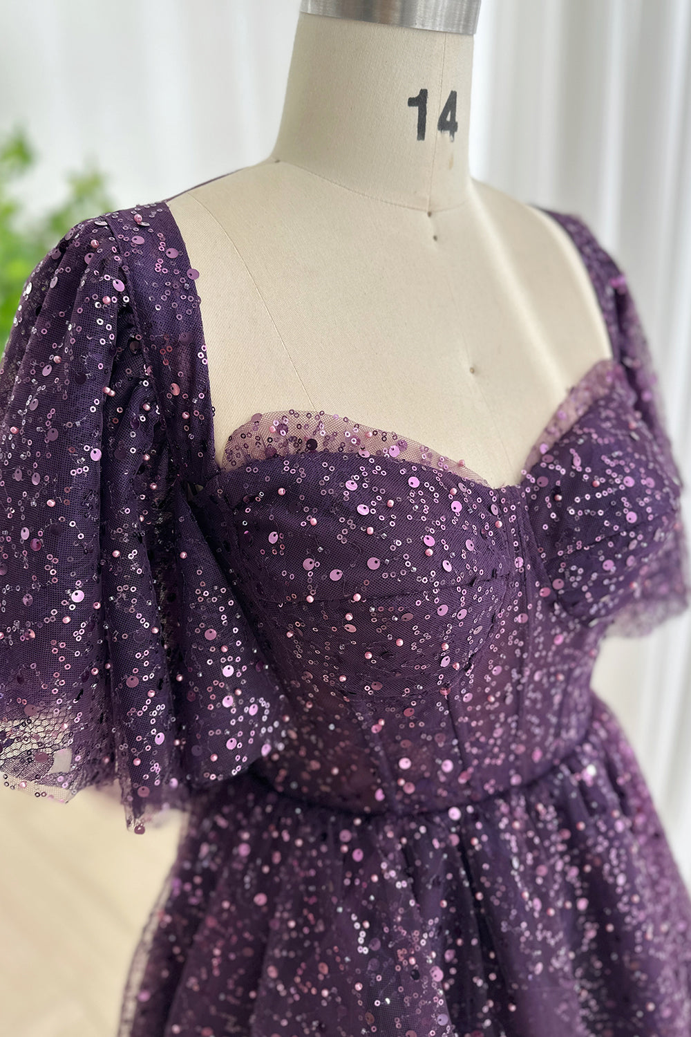 Bust detail glitter mesh bodice design highlighting curved cups delicate shimmer overlay tailored seams feminine structure close view composition