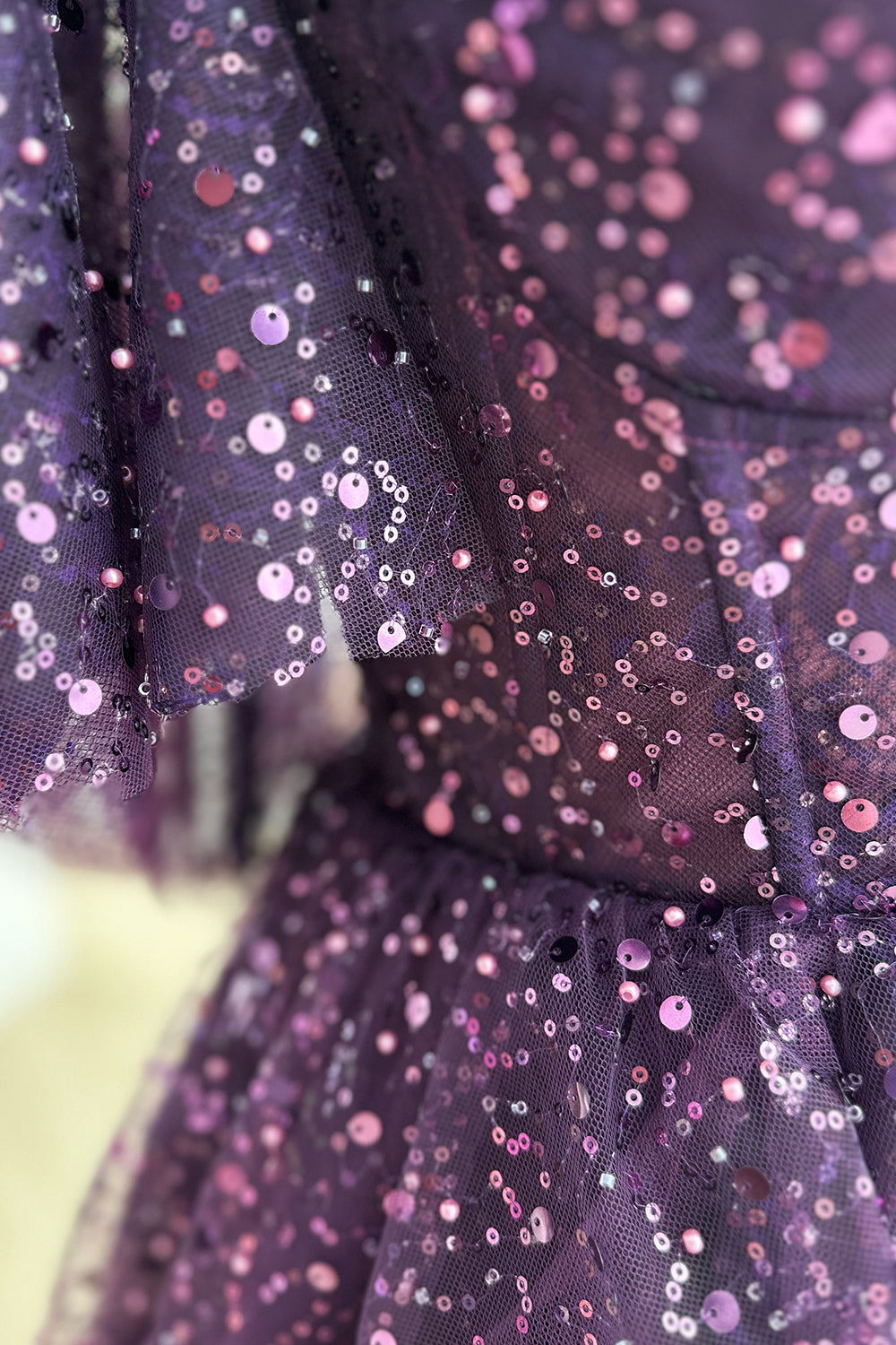 Macro sequin texture purple fabric closeup displaying reflective embellishments scattered pattern intricate surface detail luminous artistic capture