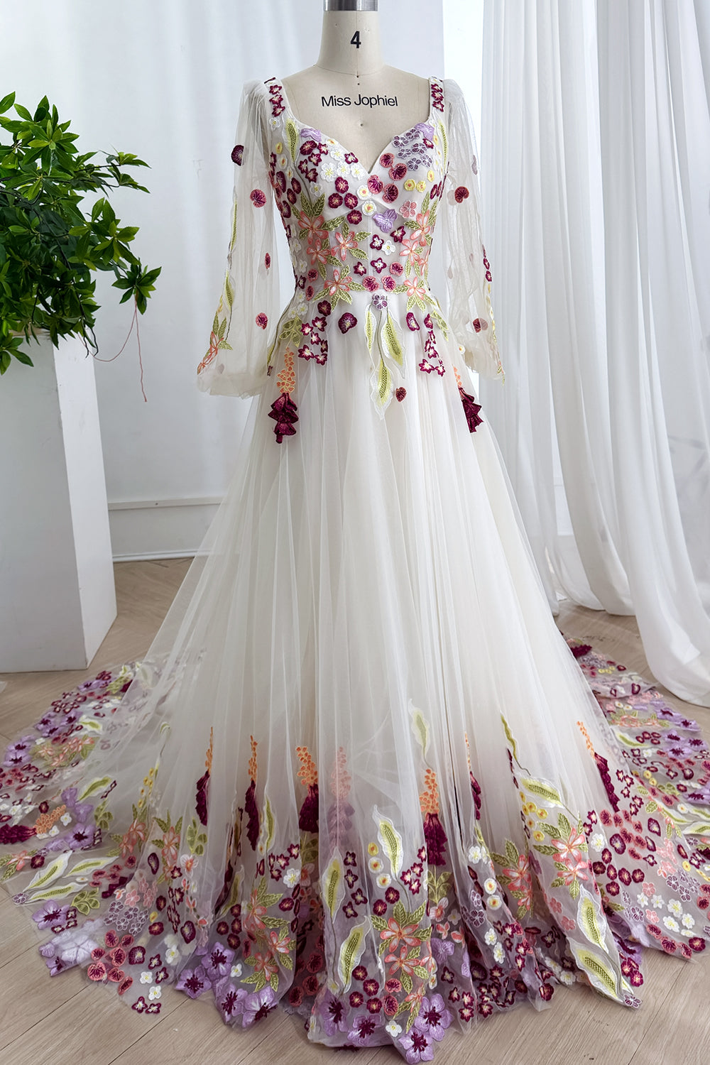 Dreamlike ivory couture featuring magenta blossoms cascading cathedraltrain alongside airy silhouette beneath luminous atelier