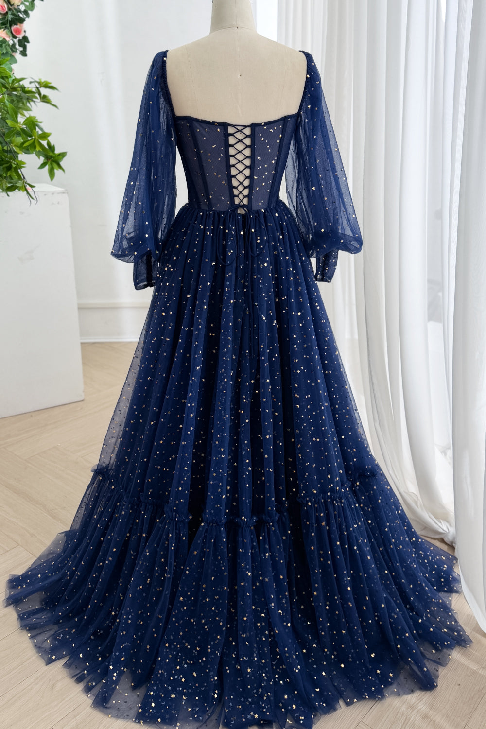 Studio shot highlights floor hem, gathered skirt volume, shimmering night-sky fabric, chapel silhouette, dramatic drape flow.