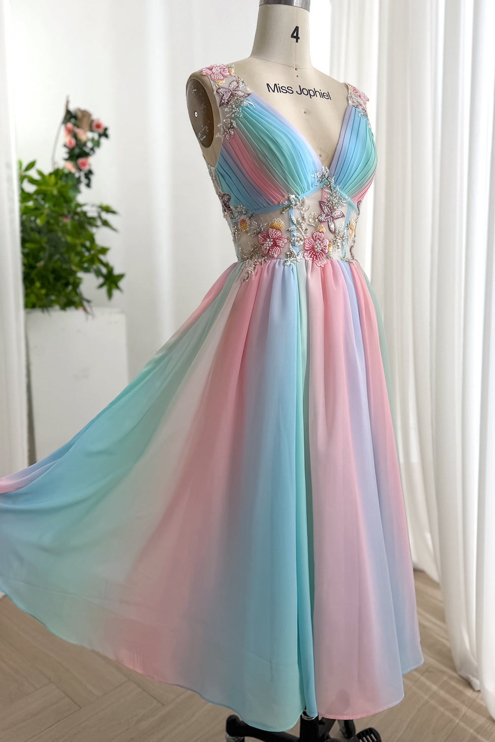Full studio photo presents dreamy multicolor A-line dress, soft draped skirt, beaded flowers for garden celebrations feeling.