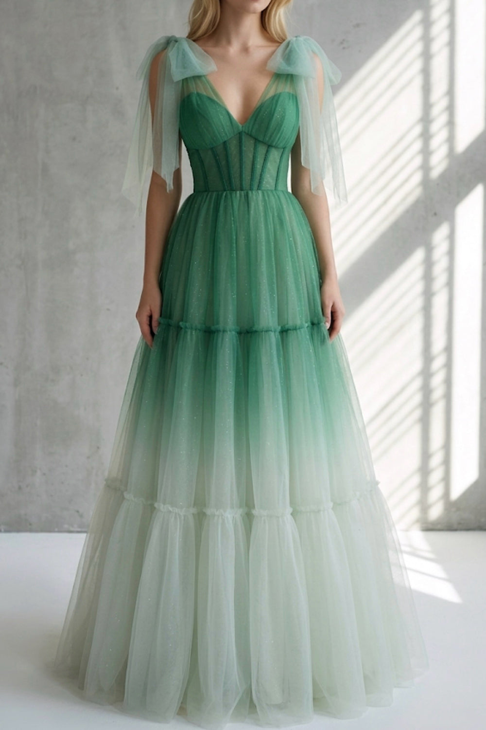 Model wearing aquamarine fantasy ballgown, plunging neckline, ethereal overlay, bridal guest promenade styling sunlight glow.