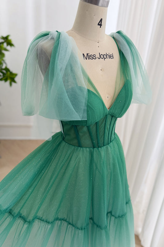 Closeup emerald glitter tulle gown showing V-neck corset bodice, boning, puff shoulder drapes, MissJophiel mannequin studios.