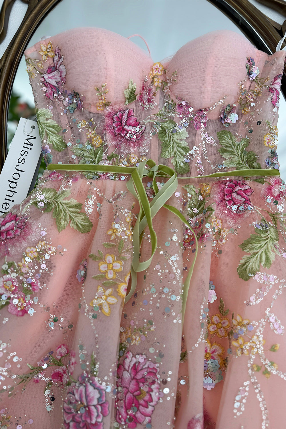Close detail captures pleated pink cups, multicolor blooms, sequinned branches, velvet sash, couture handmade fine craftwork!