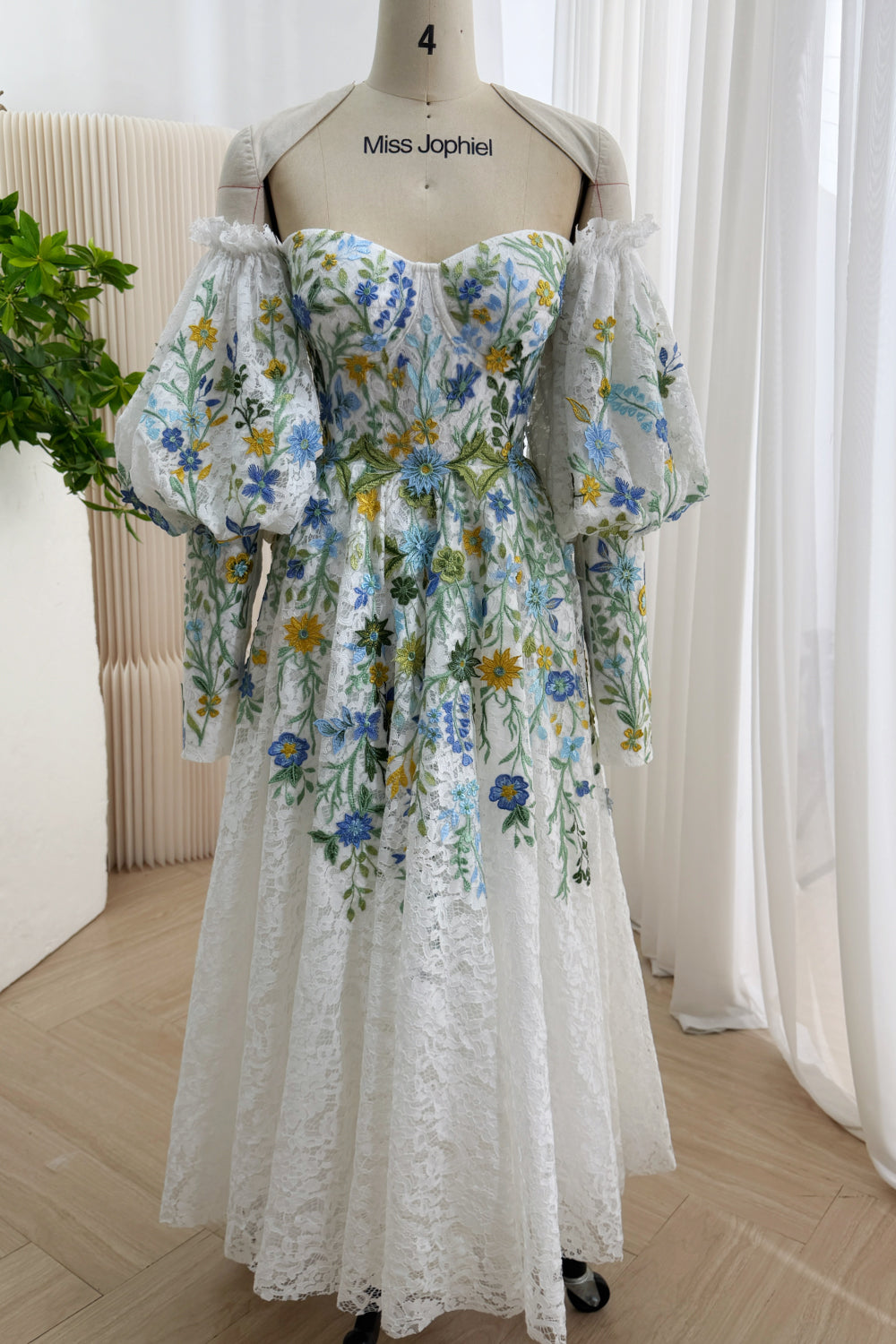 Front view: white wildflower embroidered lace tea-length gown, sweetheart corset, puff sleeves, garden wedding styling allure