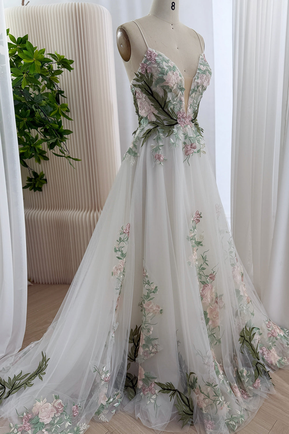 Frontal fullview showcase features whimsical garden wedding dress, slender shoulder cords, voluminous sweep, spring elegance.