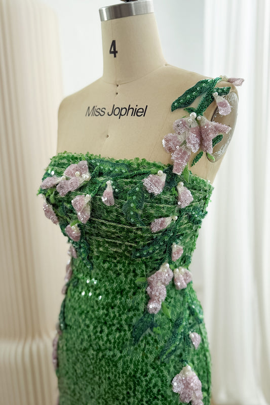 Close-up of the green gown's ruched bodice and floral shoulder strap, with pink sequined flowers, green leaves and pearl-like beads.