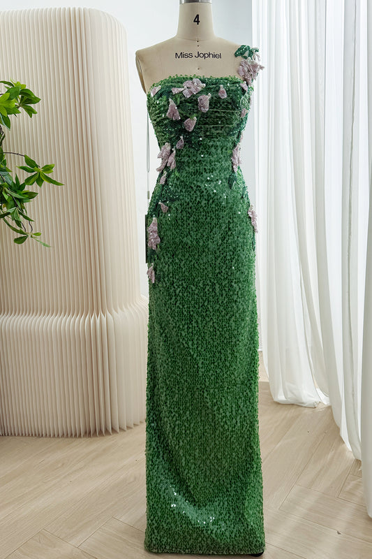 Front view of a green floor-length sequin gown with one floral shoulder strap, a ruched bodice and pale pink flower appliques.