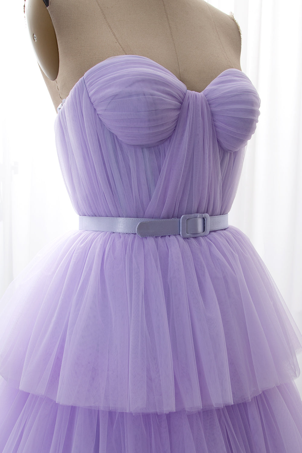 Soft purple ballgown with fitted top and voluminous layered skirt for luxurious gala appearances