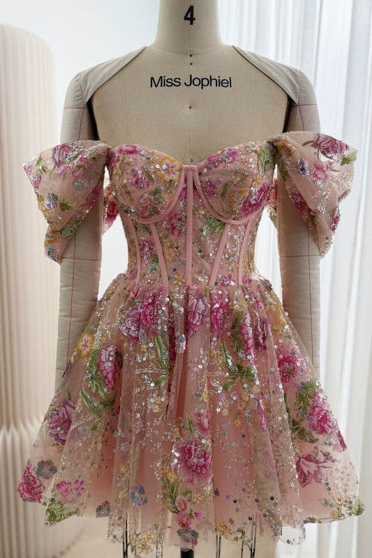 Front view of a blush pink floral sequin mini dress with off-the-shoulder sleeves, sweetheart corset bodice and flared skirt on a mannequin.
