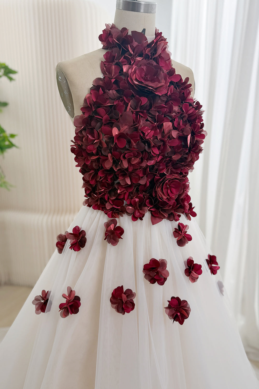 Close-up of burgundy 3D floral and rosette halter bodice