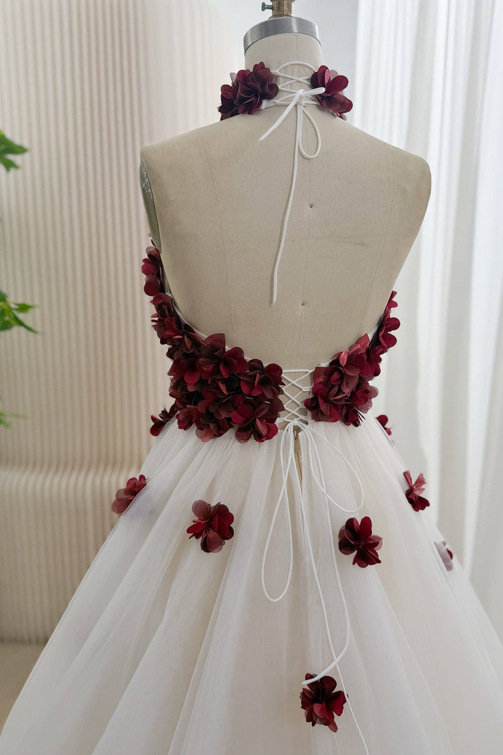 Open back with lace-up corset detail and halter tie on floral gown