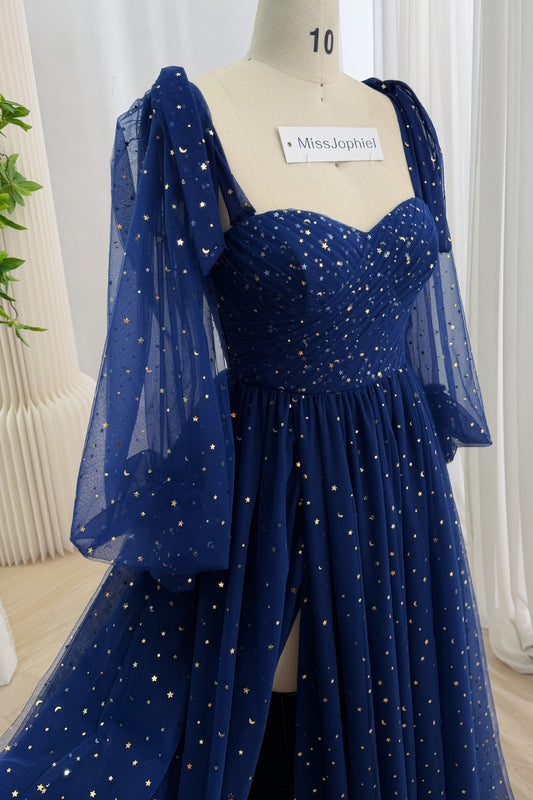 Close view of a dark navy celestial tulle gown with a ruched sweetheart bodice and sheer bell sleeves